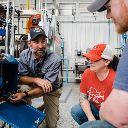 Instructor pointing at training electrical board