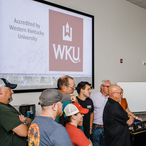 Classroom projector showing Accredited by Western Kentucky University